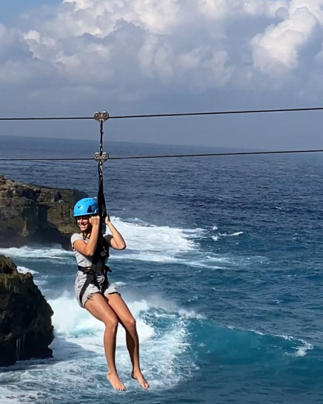 Woman zip lining over Nusa Ceningan