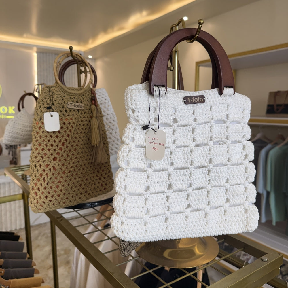 Two handbags, one white and one brown, on display in Island Look, Nusa Lembongan