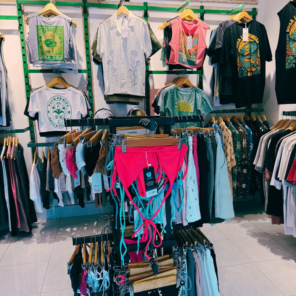 Island Paradise Outlet Clothing store in Nusa Lembongan with racks of shirts and accessories on display.