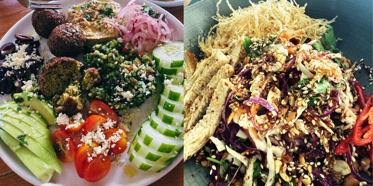 Two plates of assorted salads with various ingredients on a wooden table served at Karana Pool Bar and Restaurant , Nusa Lembongan