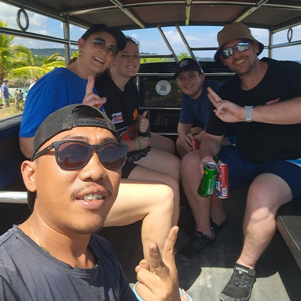 Group of people in a local Lembongan Taxi, posing for a photo with with Tour Operator Wayan