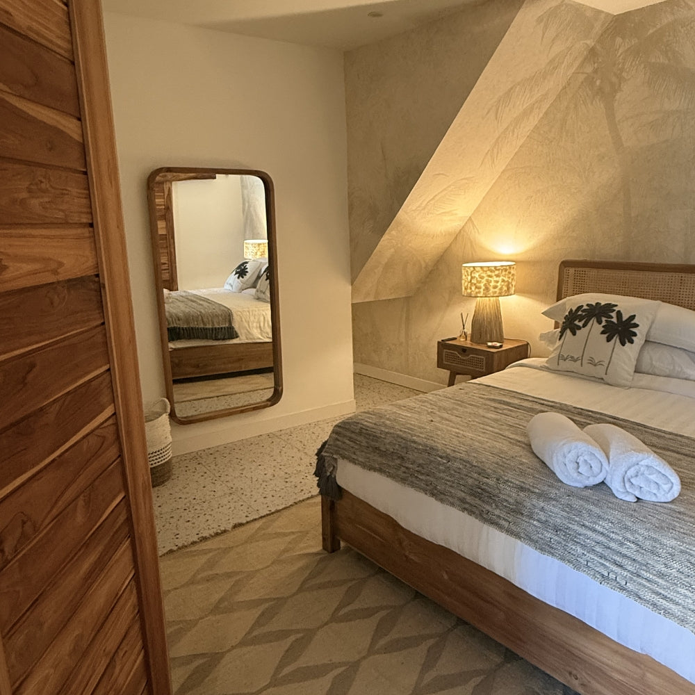 Main Bedroom of Villa Alam with wooden bed, mirror, and lamp in a cozy room, located in Nusa Lembongan